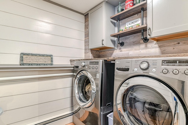 34 Clark Ln, Harriman, NY 10926 - washroom featuring washer and clothes dryer, cabinet space, a baseboard radiator, and wooden walls