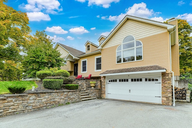 34 Clark Ln, Harriman, NY 10926 - view of front of home featuring an attached garage, stone siding, asphalt driveway, and a chimney