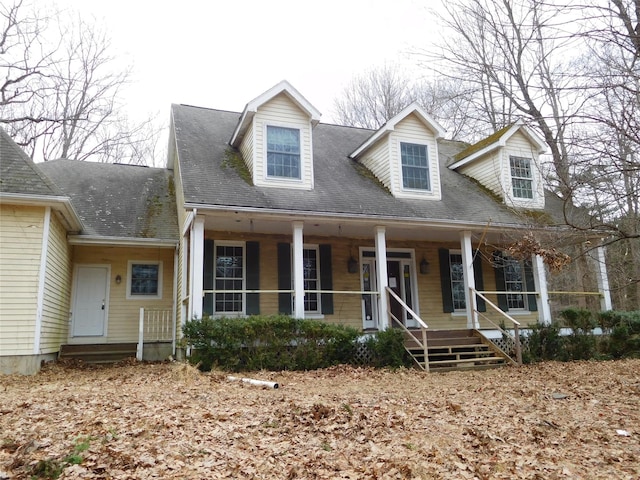 cape cod house featuring a porch