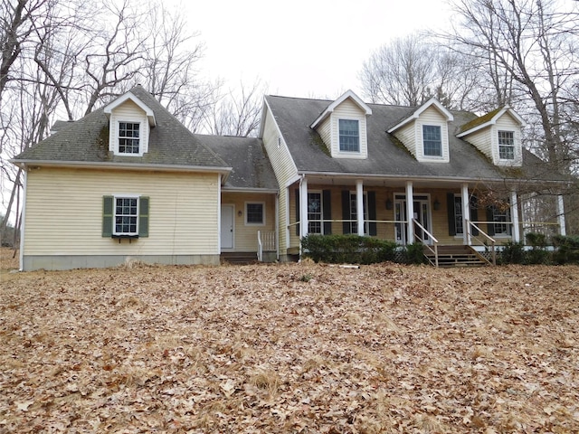 cape cod-style house featuring covered porch