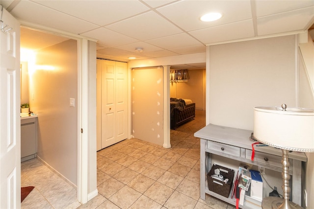 interior space featuring light tile patterned flooring and a paneled ceiling