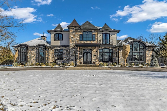 french country home featuring stone siding