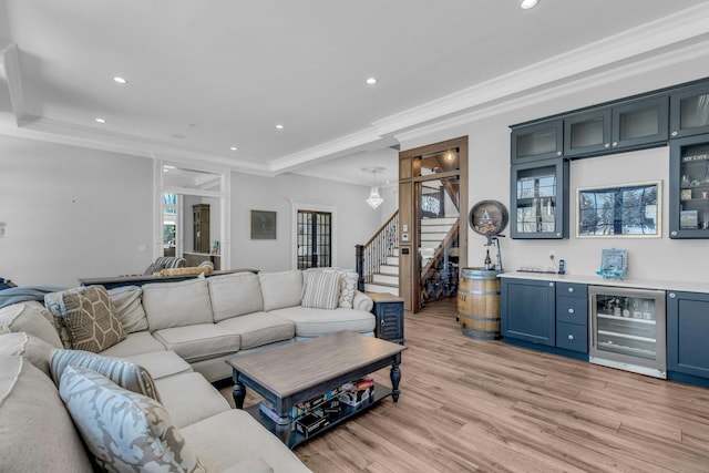 living area with wine cooler, light wood-style flooring, stairs, wet bar, and crown molding