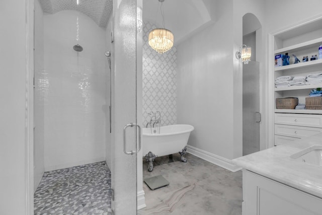 full bath with a shower stall, a freestanding bath, vanity, and baseboards