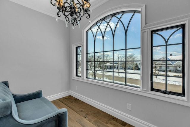 sitting room featuring crown molding, wood finished floors, a wealth of natural light, and baseboards