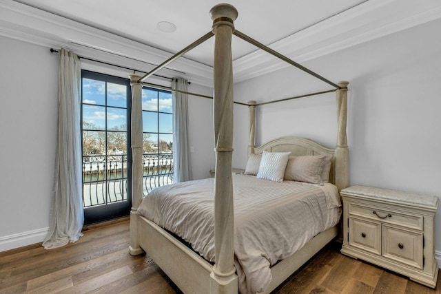 bedroom featuring a water view, baseboards, access to exterior, ornamental molding, and dark wood finished floors