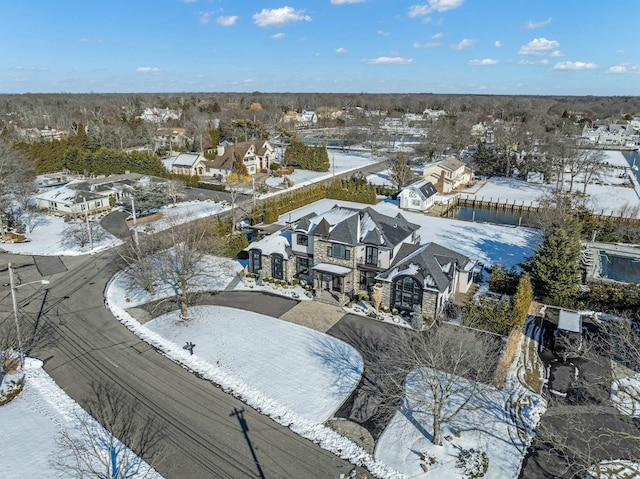 snowy aerial view featuring a residential view