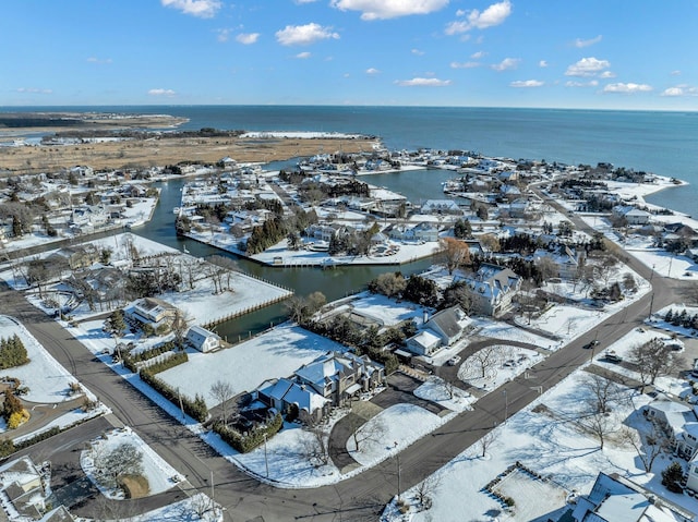 snowy aerial view featuring a water view