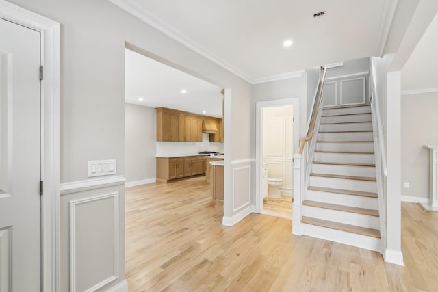 interior space with ornamental molding, recessed lighting, baseboards, and wood finished floors