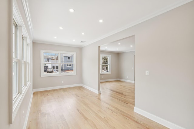 unfurnished room with light wood-type flooring, baseboards, crown molding, and recessed lighting