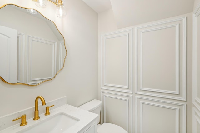 bathroom featuring vanity and toilet