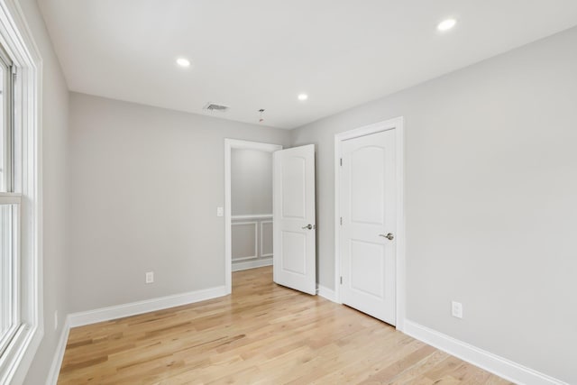 unfurnished bedroom featuring baseboards, light wood-style flooring, visible vents, and recessed lighting