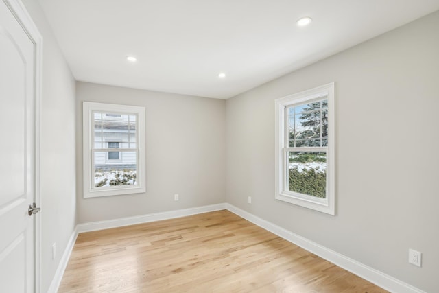 unfurnished bedroom with recessed lighting, multiple windows, and baseboards