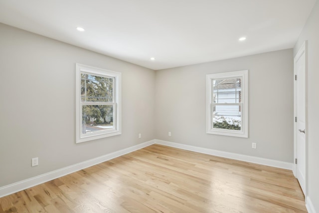 unfurnished room with light wood-type flooring, baseboards, and recessed lighting