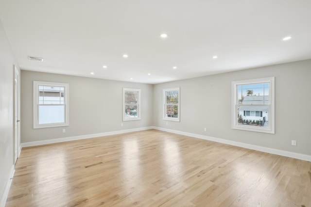 empty room featuring recessed lighting, visible vents, and a healthy amount of sunlight