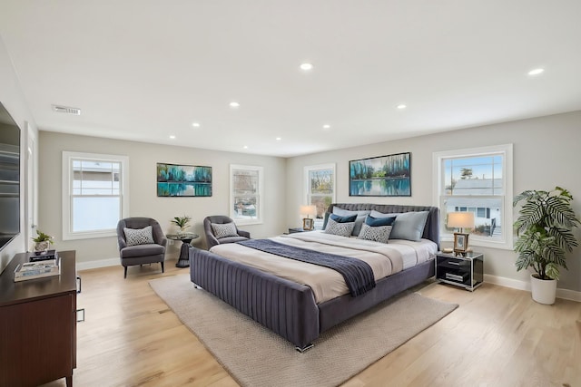 bedroom featuring light wood-type flooring, visible vents, baseboards, and recessed lighting