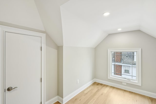 bonus room with light wood finished floors, baseboards, vaulted ceiling, and recessed lighting