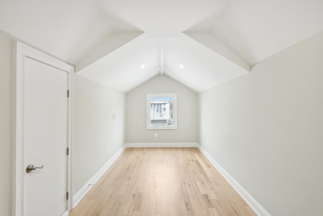 bonus room featuring lofted ceiling, baseboards, and light wood finished floors