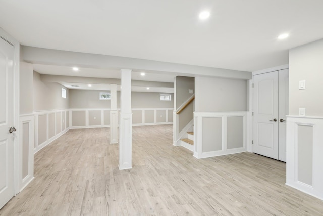basement with stairway, recessed lighting, and light wood-style floors