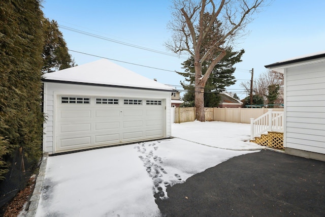 detached garage featuring fence