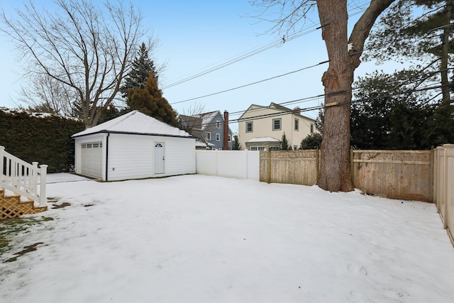 view of yard with an outbuilding, a detached garage, and fence