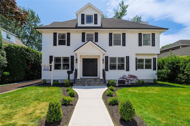12 Shepherd St, Rockville Centre, NY 11570 - view of front of property with entry steps and a front yard