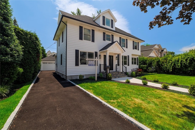 12 Shepherd St, Rockville Centre, NY 11570 - american foursquare style home with an outbuilding, a detached garage, and a front yard
