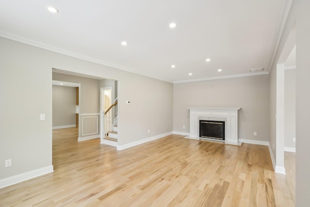 12 Shepherd St, Rockville Centre, NY 11570 - unfurnished living room featuring ornamental molding, recessed lighting, stairs, light wood finished floors, and a high end fireplace
