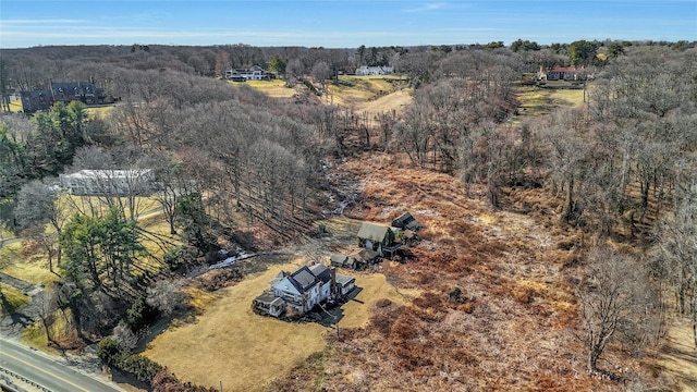 drone / aerial view featuring a wooded view