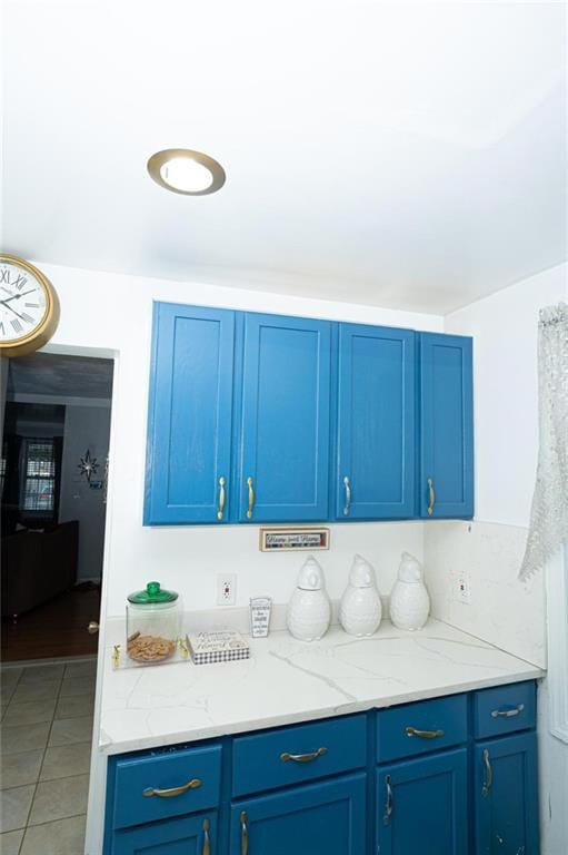 kitchen featuring blue cabinets and tile patterned flooring