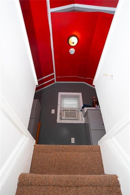 stairway with vaulted ceiling