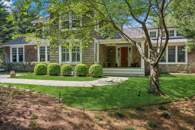 9 Owls Nest Ln, East Hampton, NY 11937 - view of front of house with a front lawn and covered porch