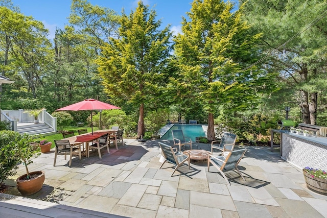9 Owls Nest Ln, East Hampton, NY 11937 - view of patio / terrace featuring an outdoor fire pit, an outdoor pool, outdoor dining area, and view of scattered trees