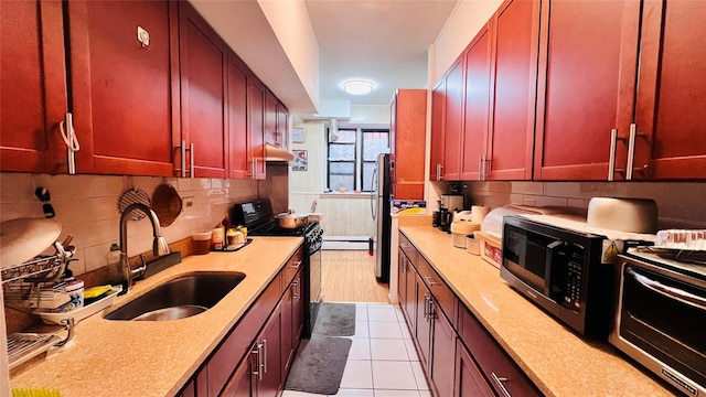 kitchen with dark brown cabinets, light countertops, a sink, and gas stove