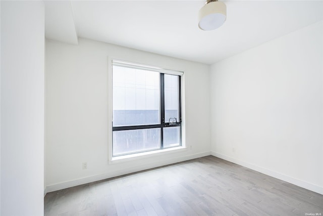 unfurnished room with light hardwood / wood-style flooring