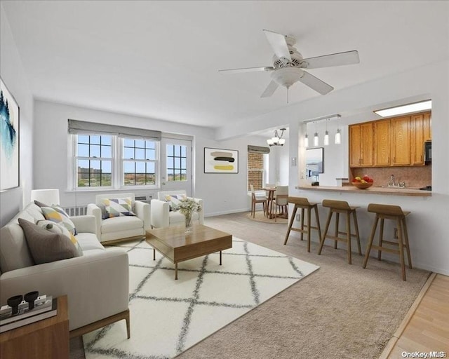 living room featuring ceiling fan and light hardwood / wood-style floors