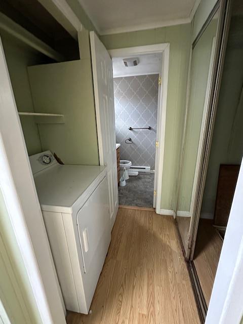 washroom featuring visible vents, light wood finished floors, laundry area, washer / clothes dryer, and tile walls