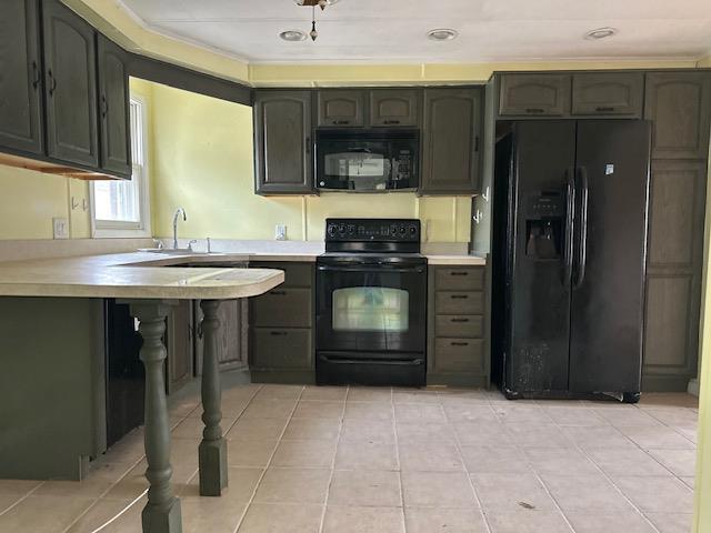 kitchen featuring black appliances, light tile patterned flooring, and light countertops