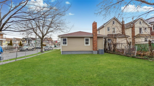 rear view of house featuring a lawn