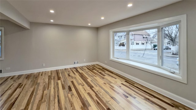 spare room featuring light hardwood / wood-style flooring