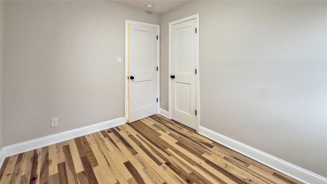 spare room with hardwood / wood-style flooring