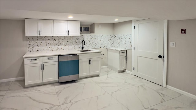 kitchen featuring dishwasher, sink, white cabinets, and backsplash