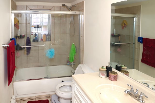 full bathroom featuring vanity, combined bath / shower with glass door, toilet, and baseboard heating