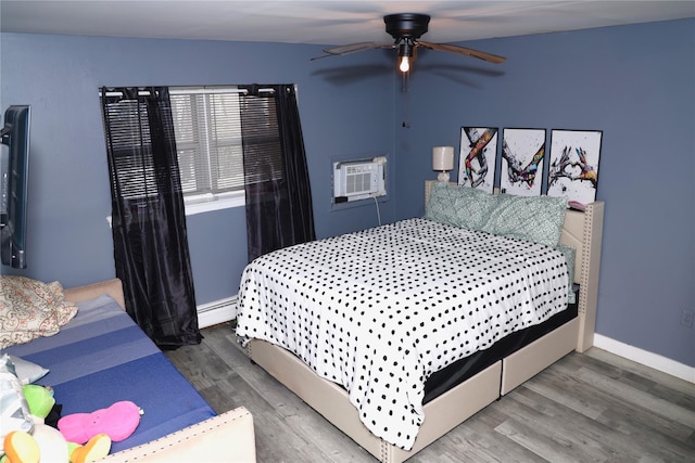 bedroom featuring ceiling fan, a wall unit AC, dark wood-type flooring, and baseboard heating