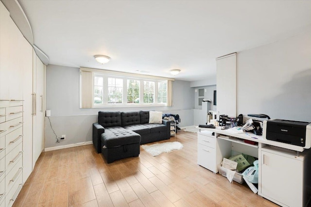 home office with light hardwood / wood-style floors