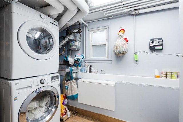 laundry room featuring stacked washer and clothes dryer