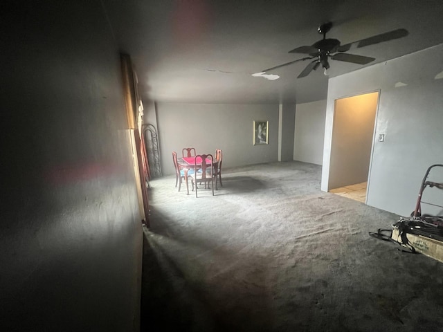 interior space featuring ceiling fan and light colored carpet