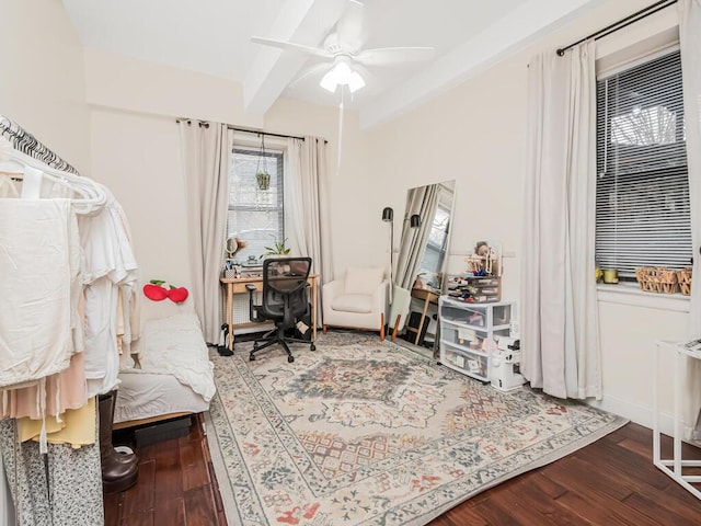 sitting room featuring beam ceiling, wood-type flooring, and ceiling fan