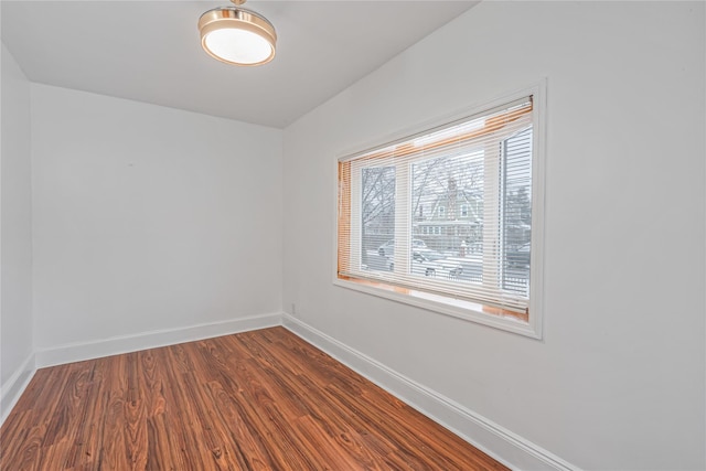 empty room with hardwood / wood-style floors