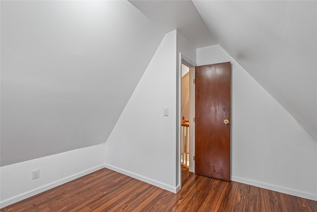 bonus room featuring dark wood-type flooring and vaulted ceiling